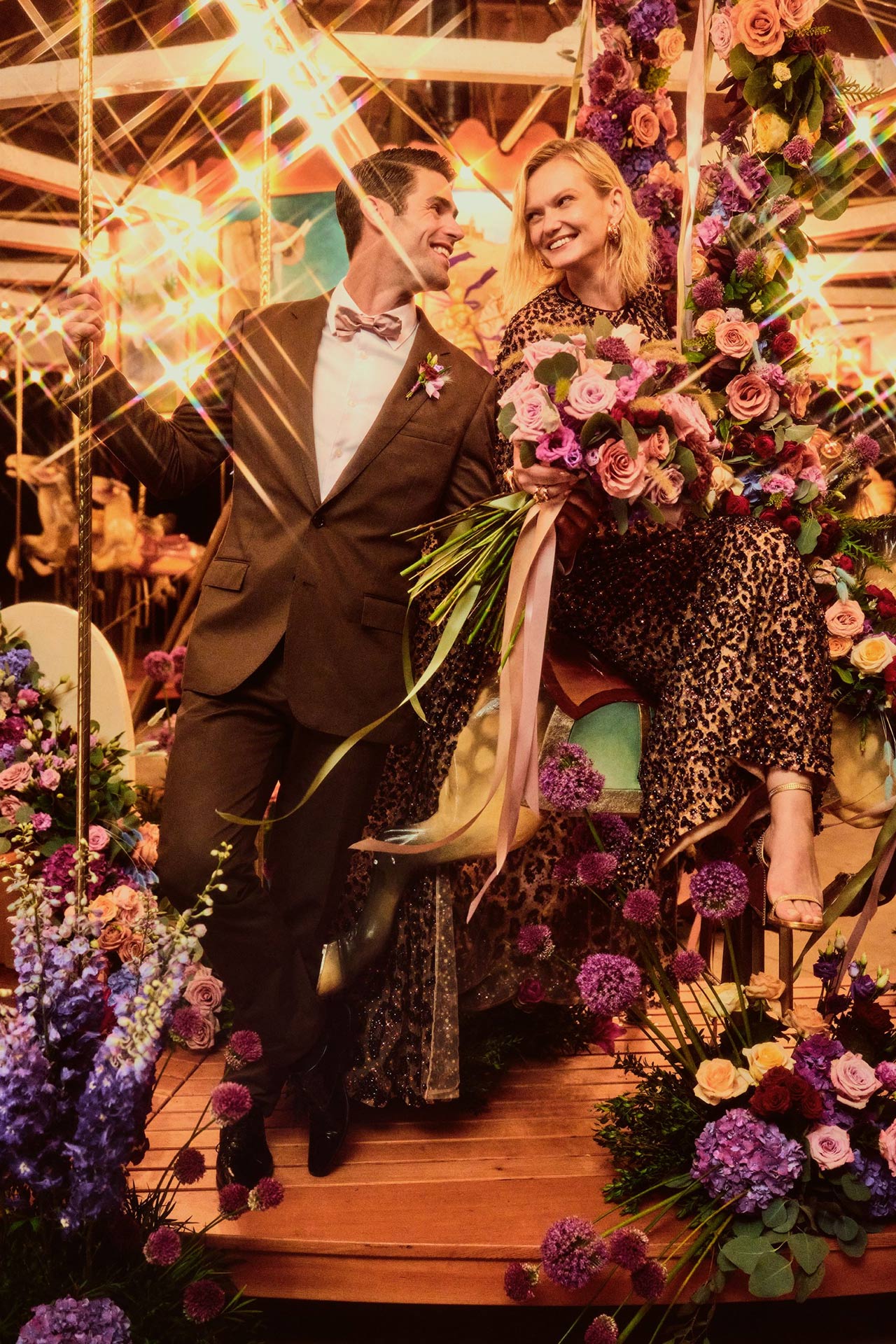 Open gallery overlay: man and women smiling in a gazebo setting with flowers up